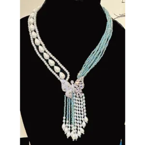 Aqua Blue Necklace in Tassel with White Shell Pearls,displayed on mannequin