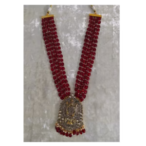 ruby colour multilayer string necklace-displayed over a velvet cloth