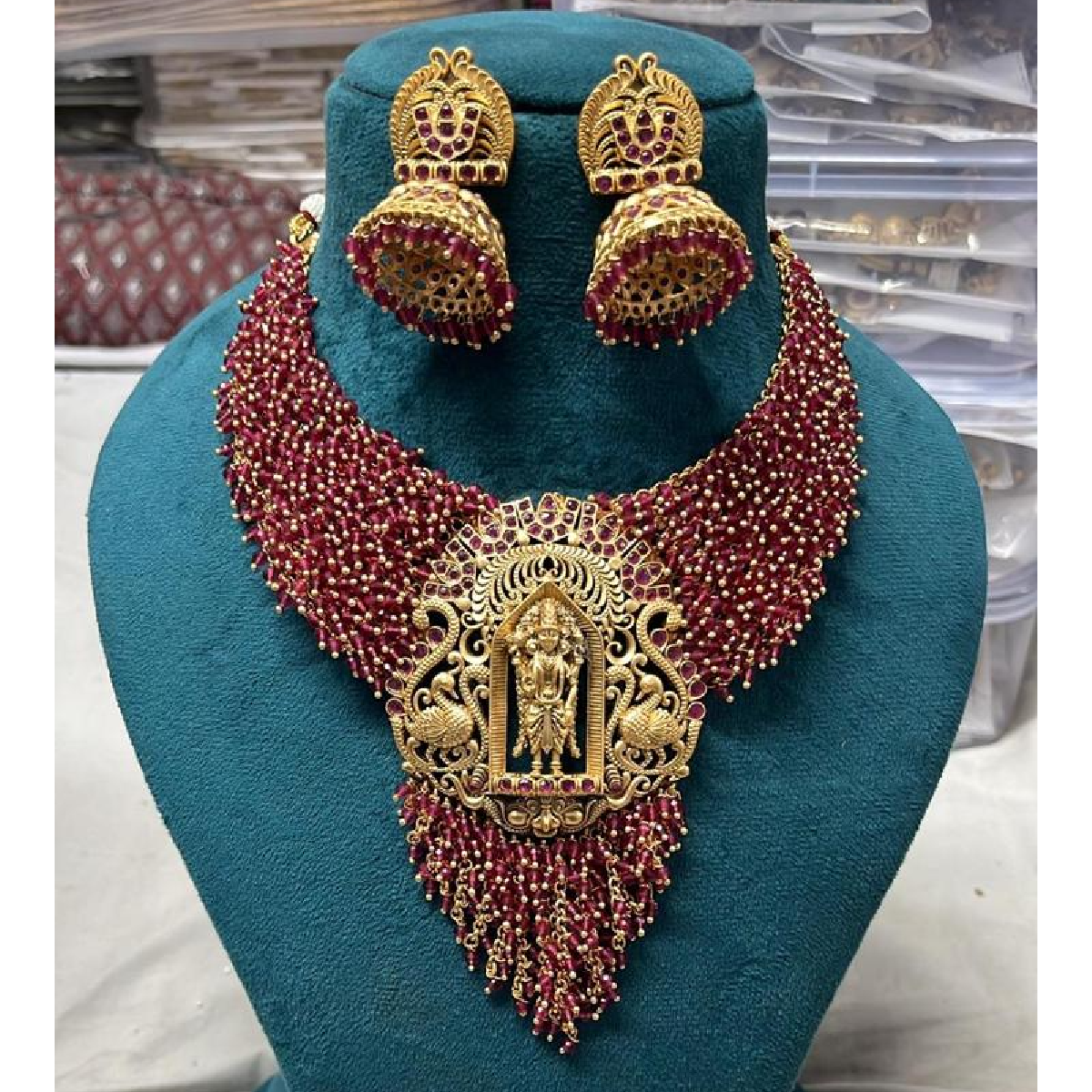 Ruby Colour Beaded Necklace Set with Golden Centerpiece displayed on mannequin