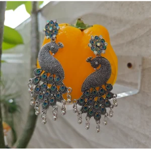 Oxidised Metal Earrings Peacock Green displayed on yellow stand