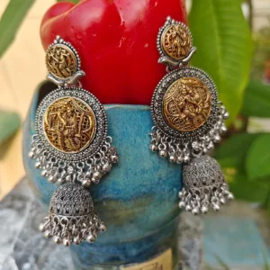 Oxidised Metal Silver Earrings in Jhumki Style displayed on red blue stand