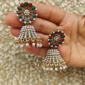 White Jhumka Earrings with Green Red Upper Dangle displayed on palm
