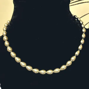 Beige Collar Necklace in Shell Pearl , displayed on a black colour stand