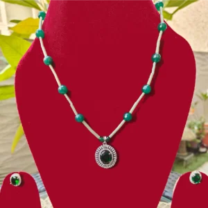 Emerald Green Long Necklace Set displayed on a red stand