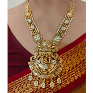 Ethnic Golden Necklace Set-Temple Design,a woman in saree is wearing the necklace