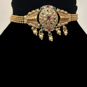 Golden Ethnic Choker with Red and Green Stones, displayed on black colour stand