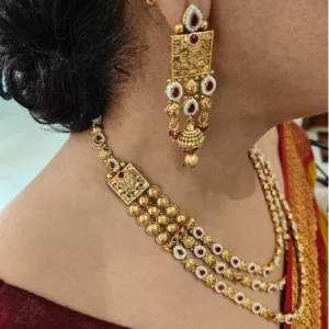 Golden Layered Necklace Set with Maang Tikka, a woman is wearing it