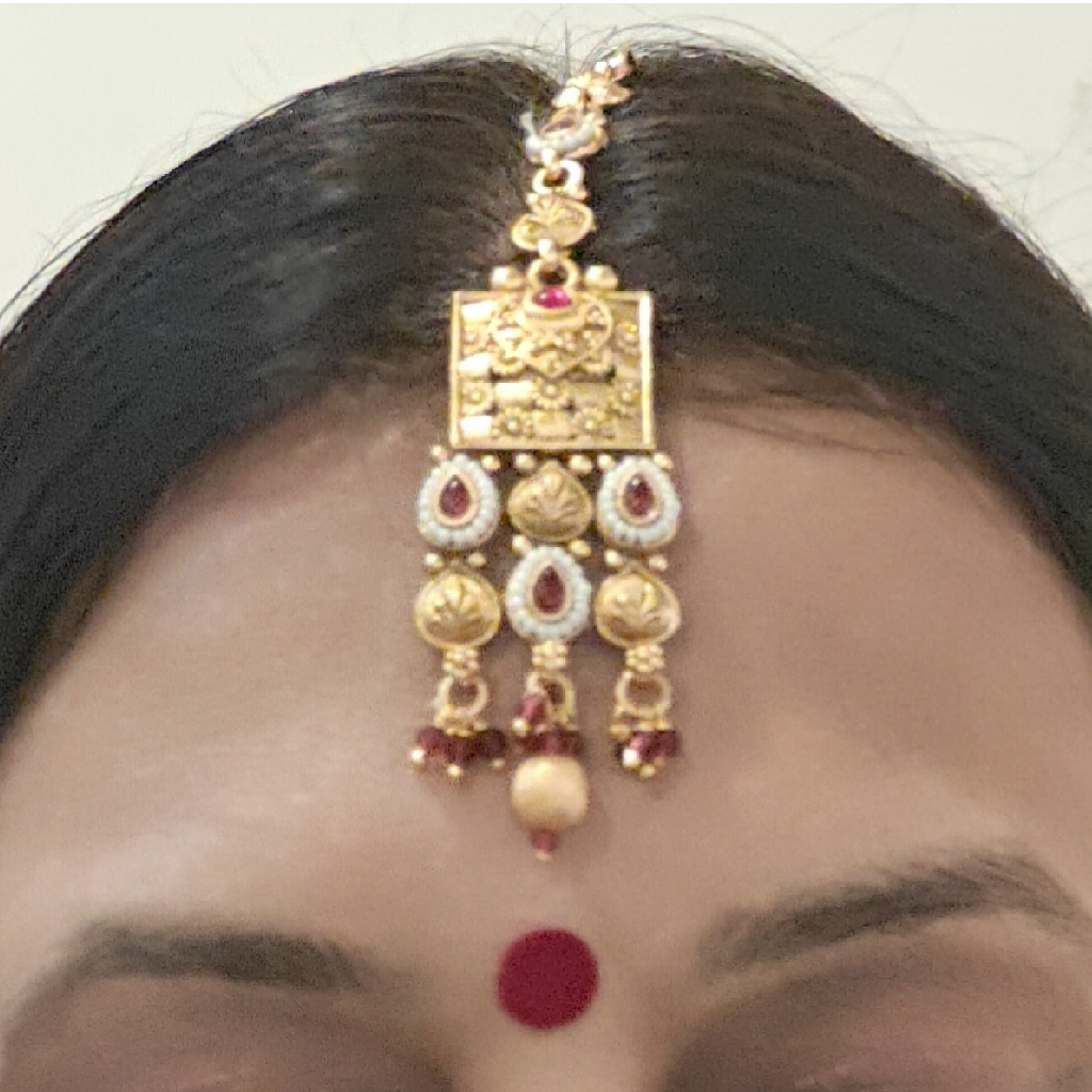 Golden Layered Necklace Set with MaangTikka Focus on maang tikka in the image
