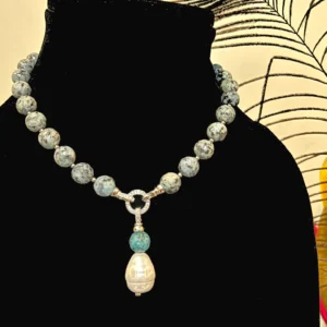 Grey Stone Necklace with Pearl Pendant, displayed on a black colour stand