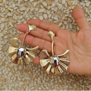 Metal Golden Earrings-Long Butterfly Danglers, held in hand
