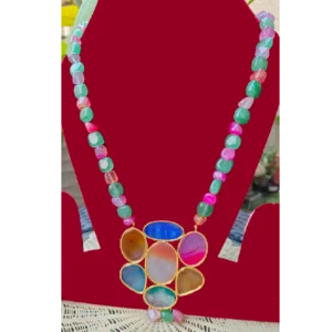 multicolor stone long necklace,displayed on a red stand