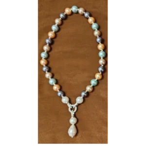 Multicolour Necklace in Pastels With Pearl Pendant placed on a brown cloth
