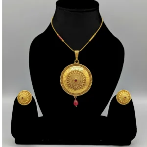 Golden brass necklace with ruby center stone on mannequin