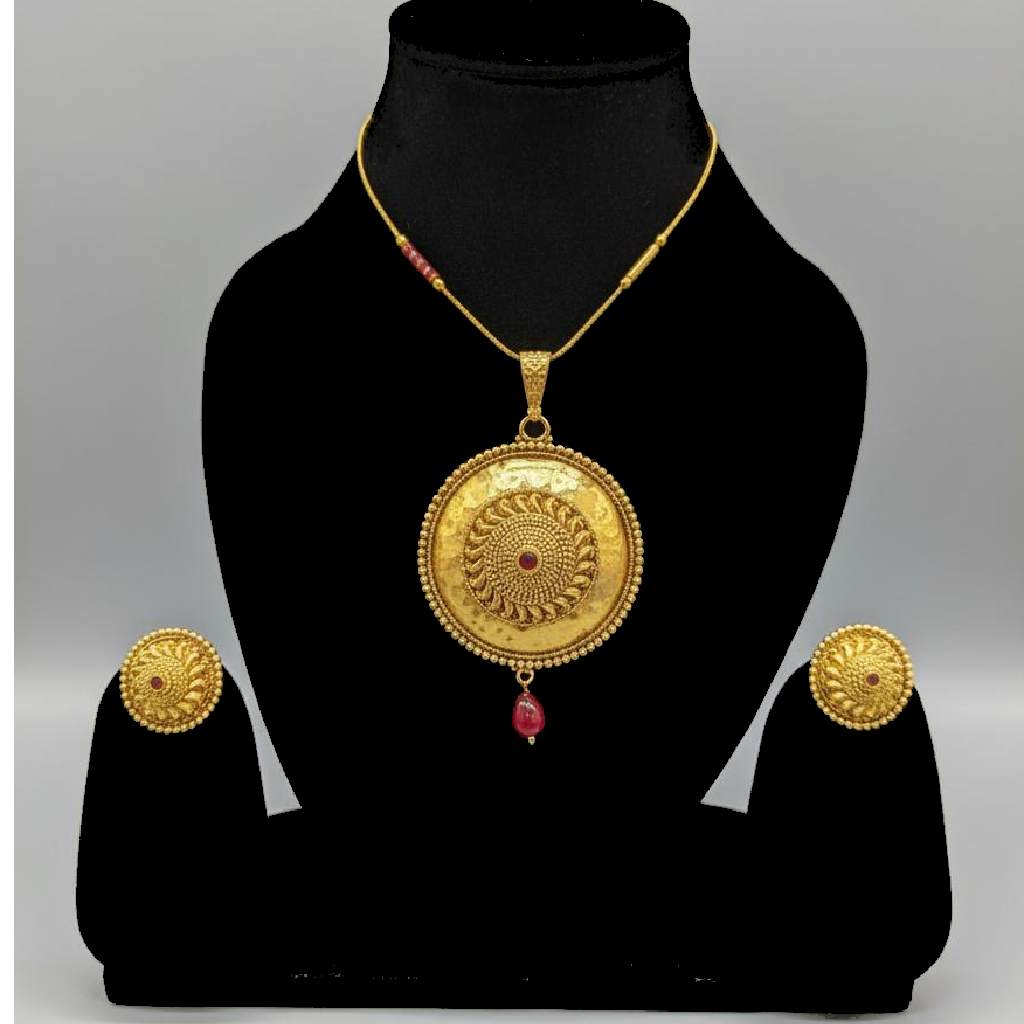 Golden brass necklace with ruby center stone on mannequin