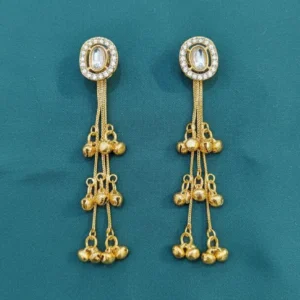 Kashmiri style long drop earrings gold toned placed on cloth