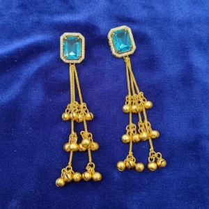 kashmiri style long earrings gold toned, displayed on coloured cloth