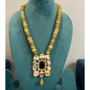 Handcrafted Mother of Pearl Kundan Necklace with Mustard Tumble Beads displayed on a mannequin