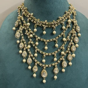 Kundan Panchlada Haar with Ivory Pearls displayed on a light green stand