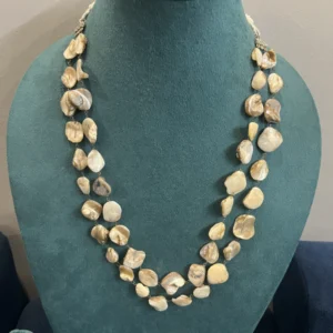 Mother of Pearl Layered Necklace displayed on a light green colour stand