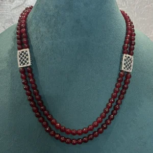Red Beads Double Strand Necklace displayed on a light green colour stand
