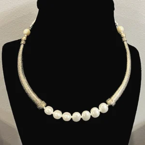Oxidized silver and pearl necklace displayed opn a black colour jewellery stand