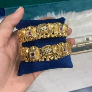 Royal Elephant Motif Antique Gold Plated Bangles displayed on blue colour stand