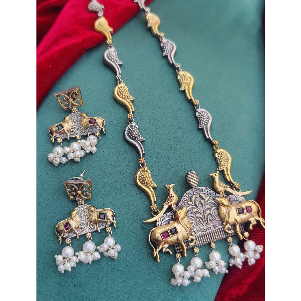 Silver Gold Polish Necklace Set in Dual Tone Cow Motif 1 Silver Gold Polish Necklace Set in Dual Tone Cow Motif displayed on a Fabric Cloth
