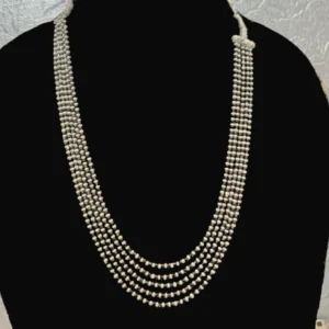 cream beads layered necklace displayed on black jewellery stand